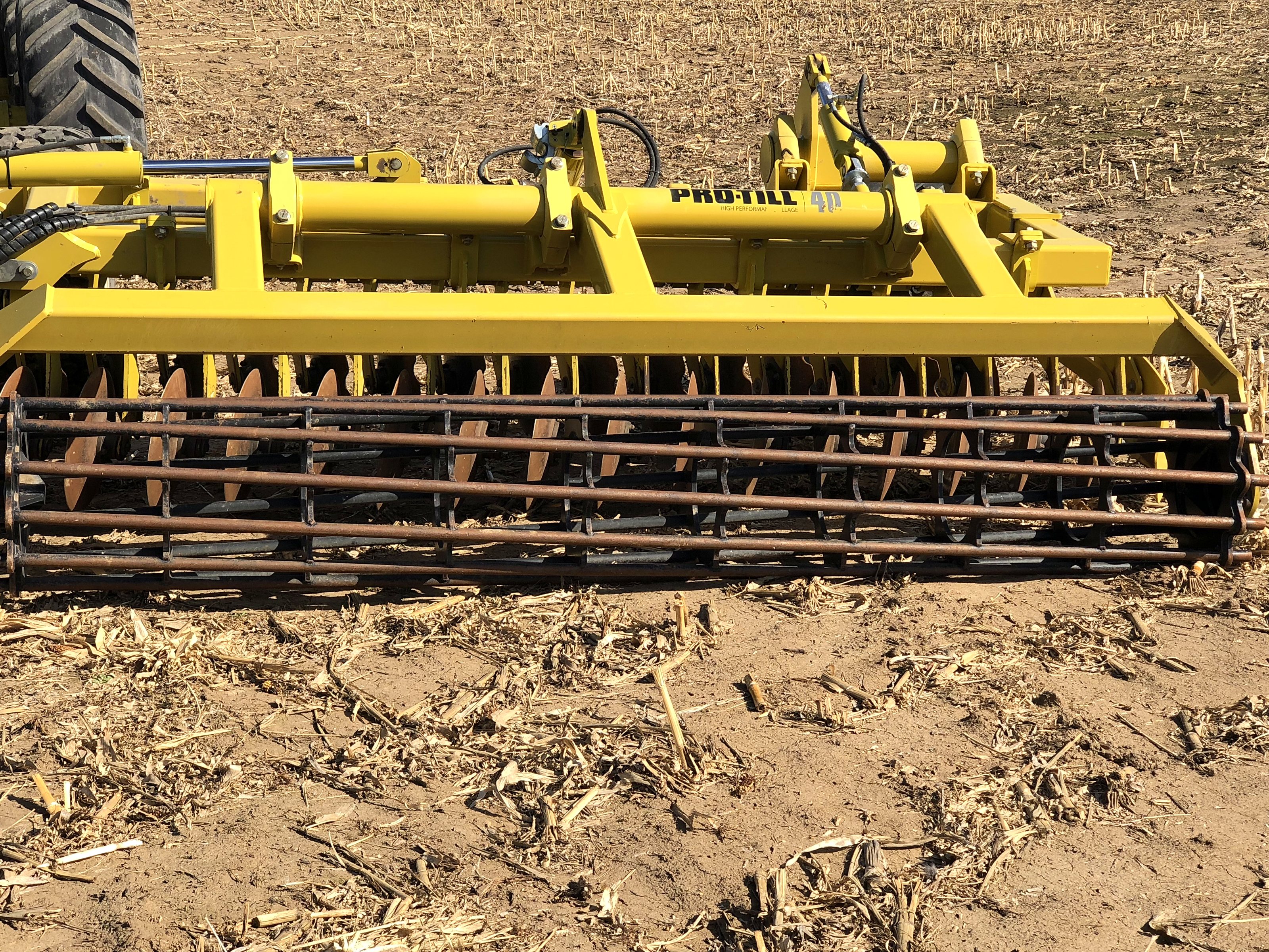 The Degelman Pro-Till high-speed disc behind the tractor, close, in spring stubble
