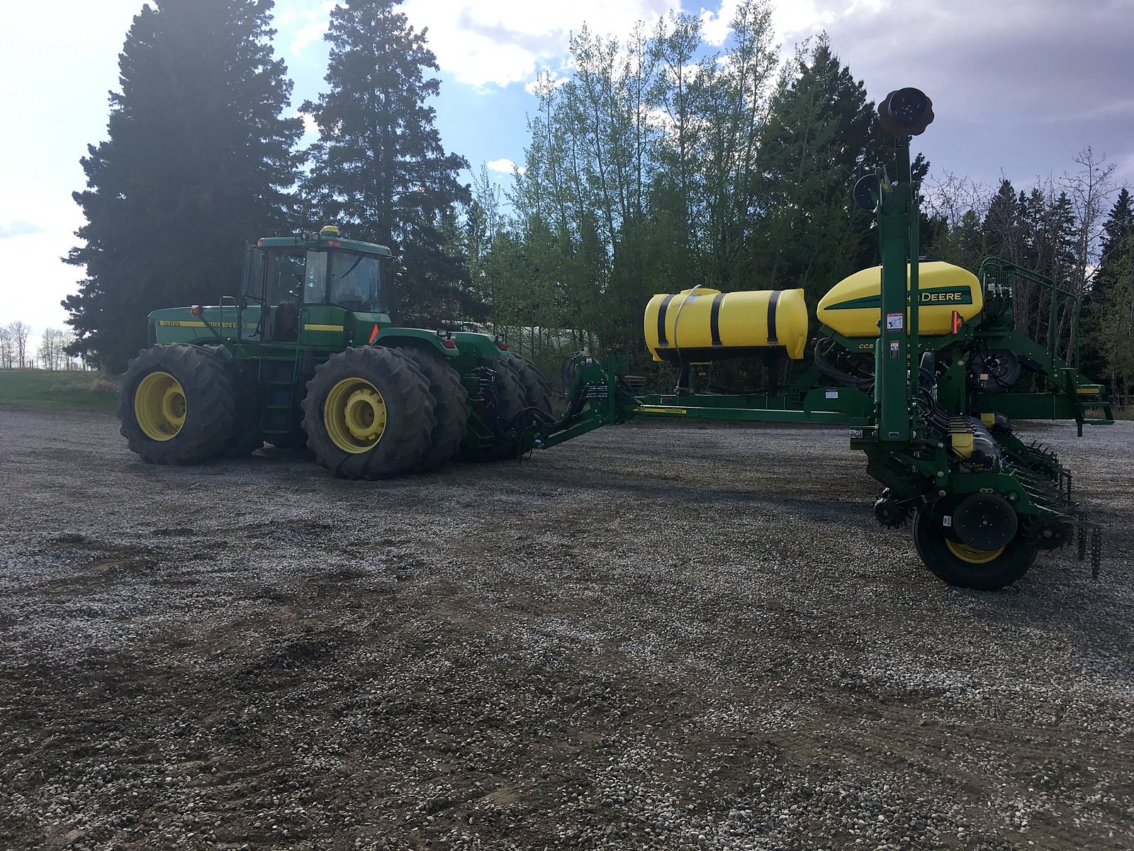 The tractor is the family. The corn seeder behind it is an implement.