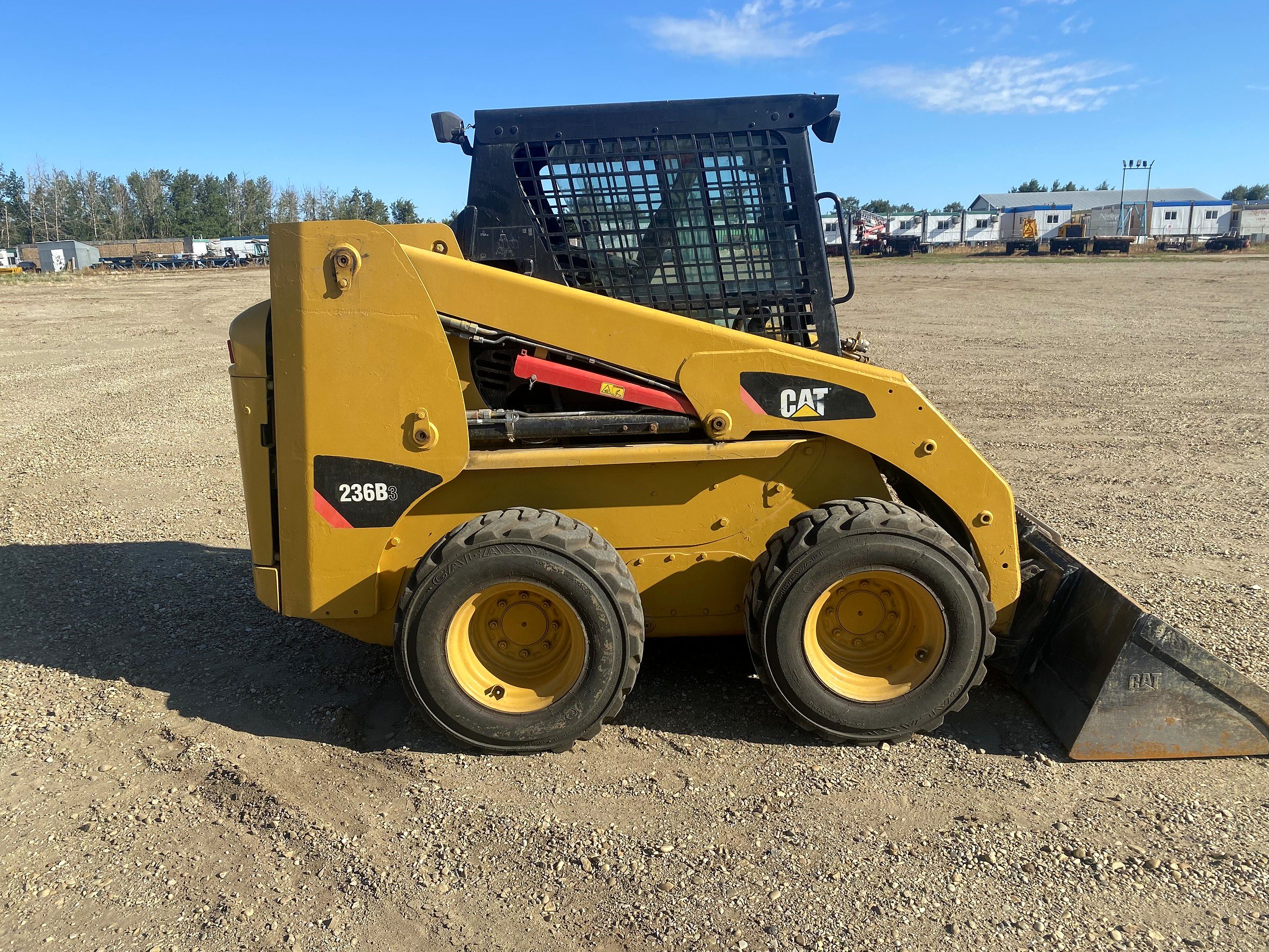 The group's Caterpillar 236 skid steer in the yard