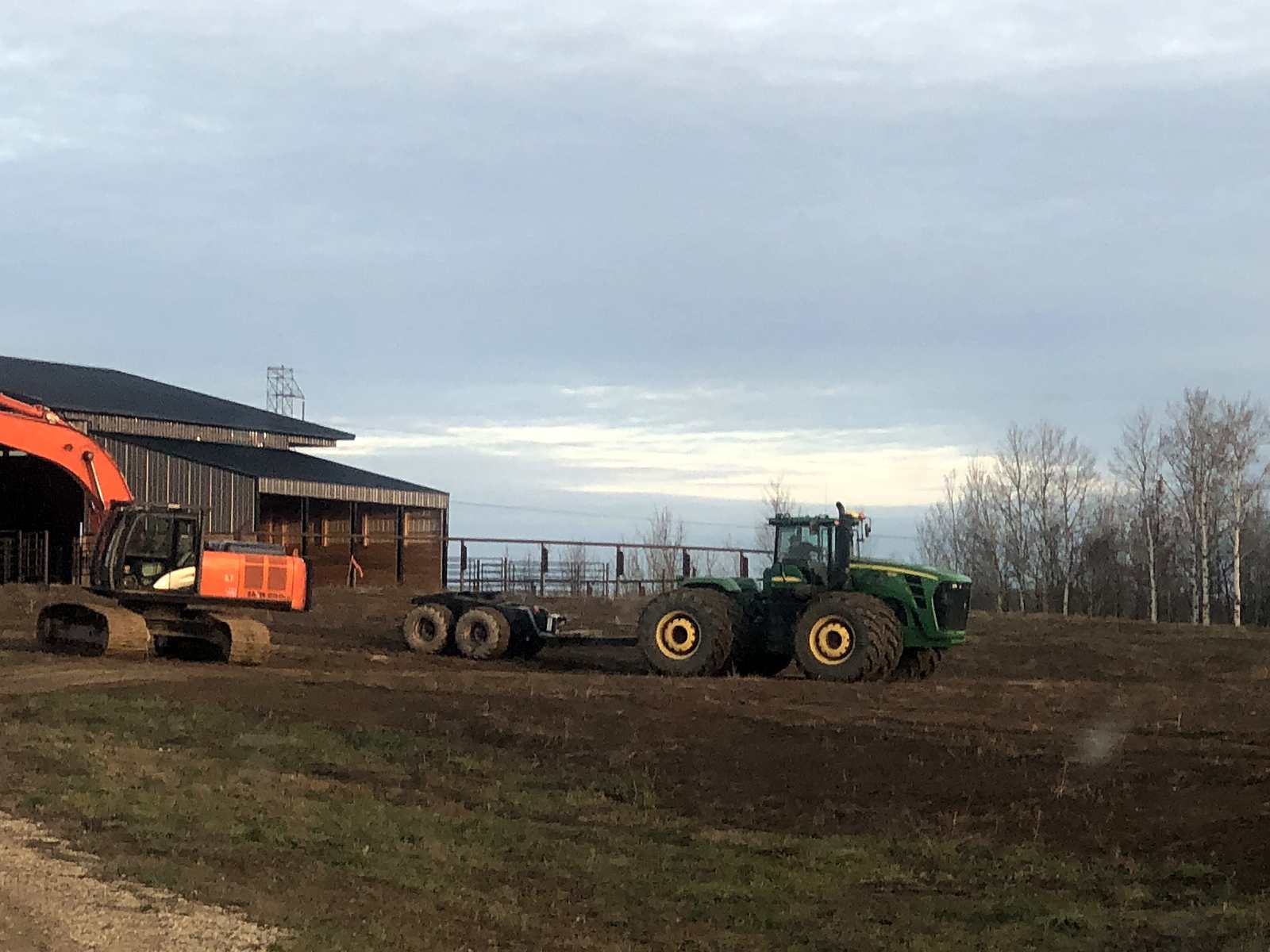 A Hitachi excavator and a John Deere tractor in the group's own yard