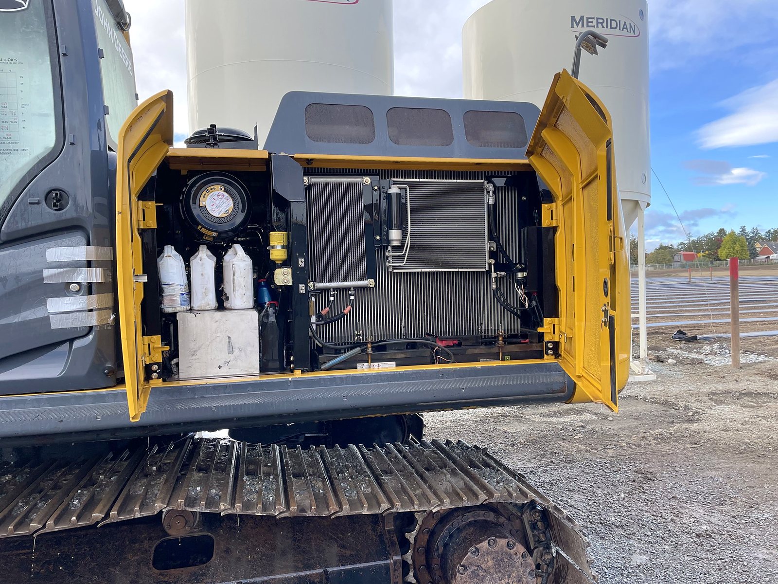 The group's John Deere 210G with the engine bay open