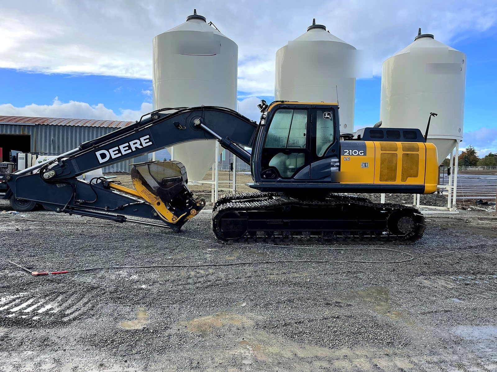 The group's John Deere 210G excavator at the tanks