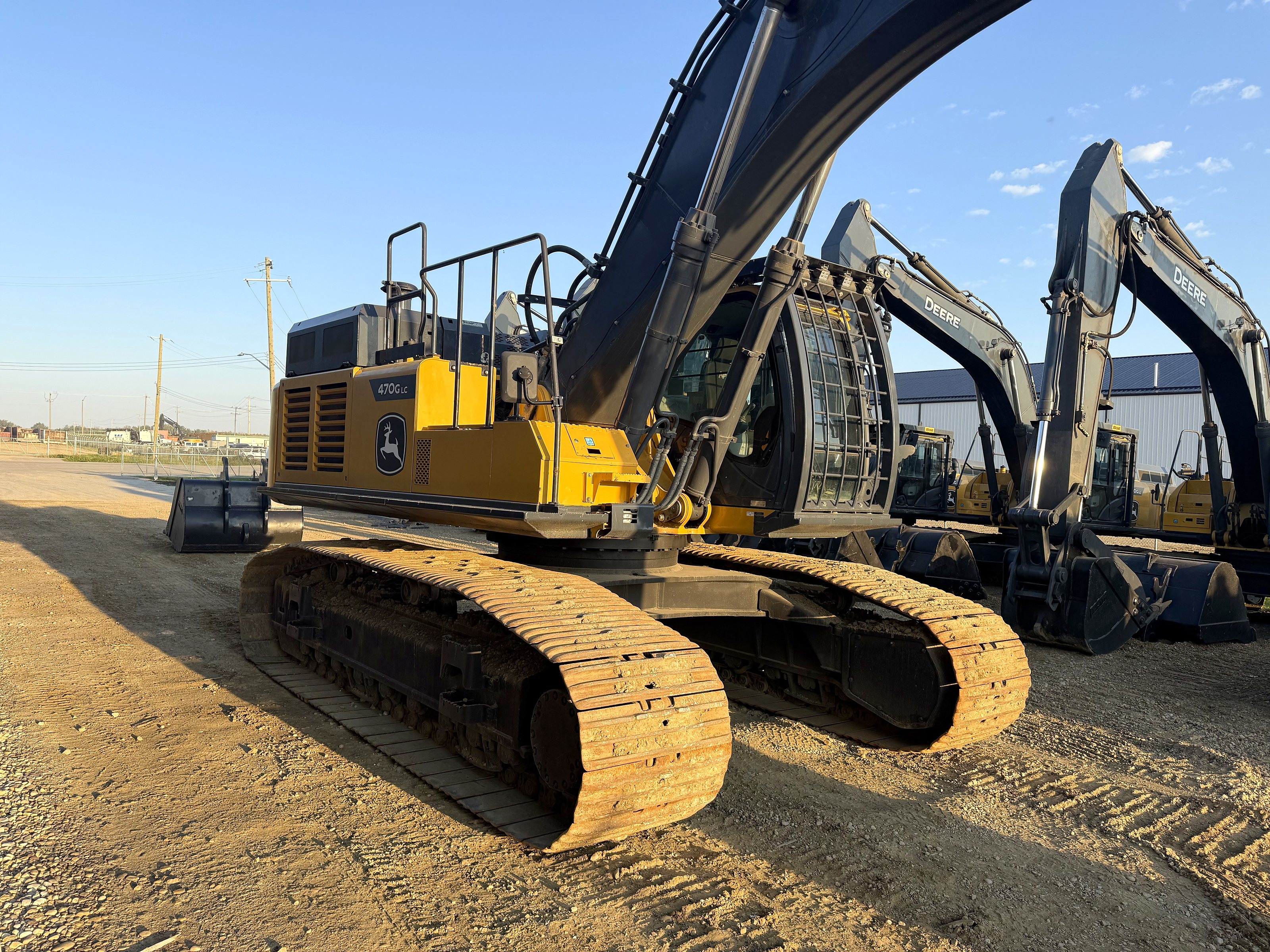 The group's John Deere excavators lined up in the yard