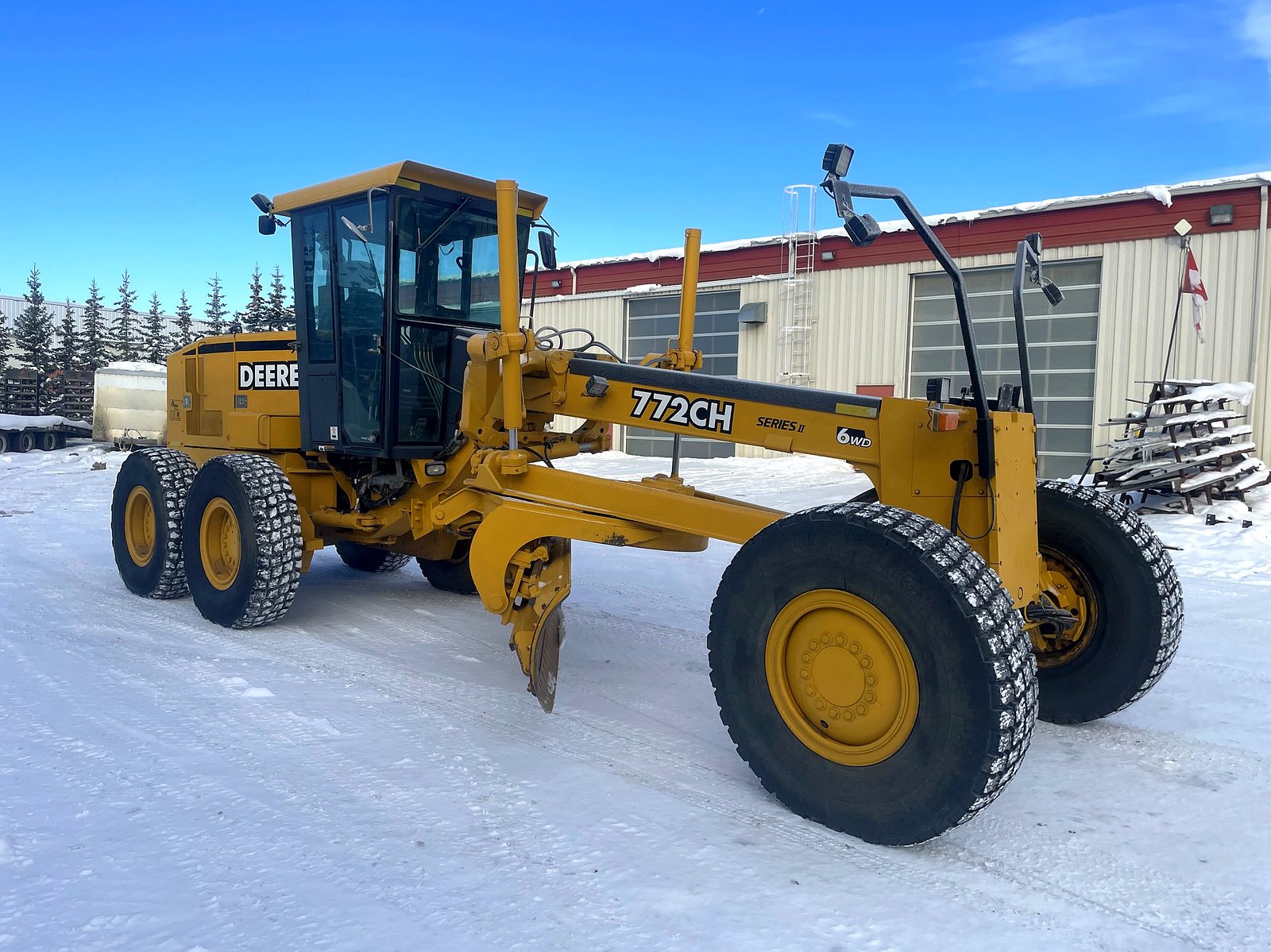 The group's John Deere 772CH motor grader on winter ground