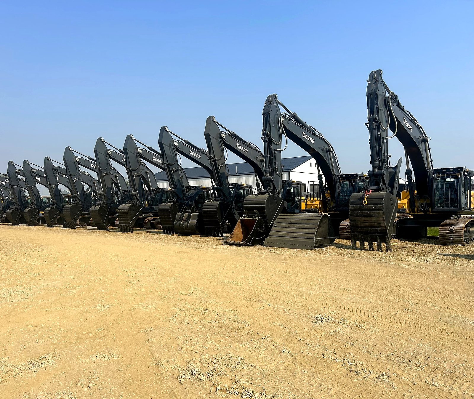 A row of the group's John Deere excavators in the yard