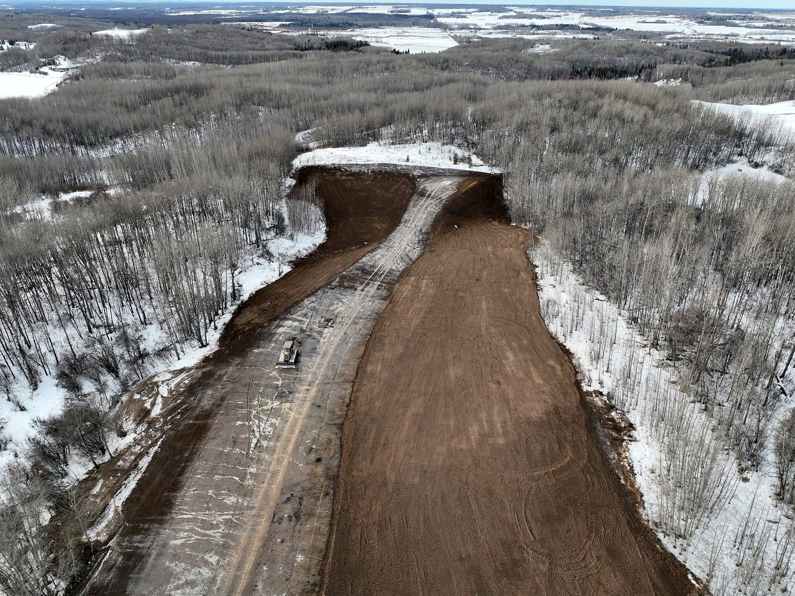 A Caterpillar dozer on a winter corridor, from the air