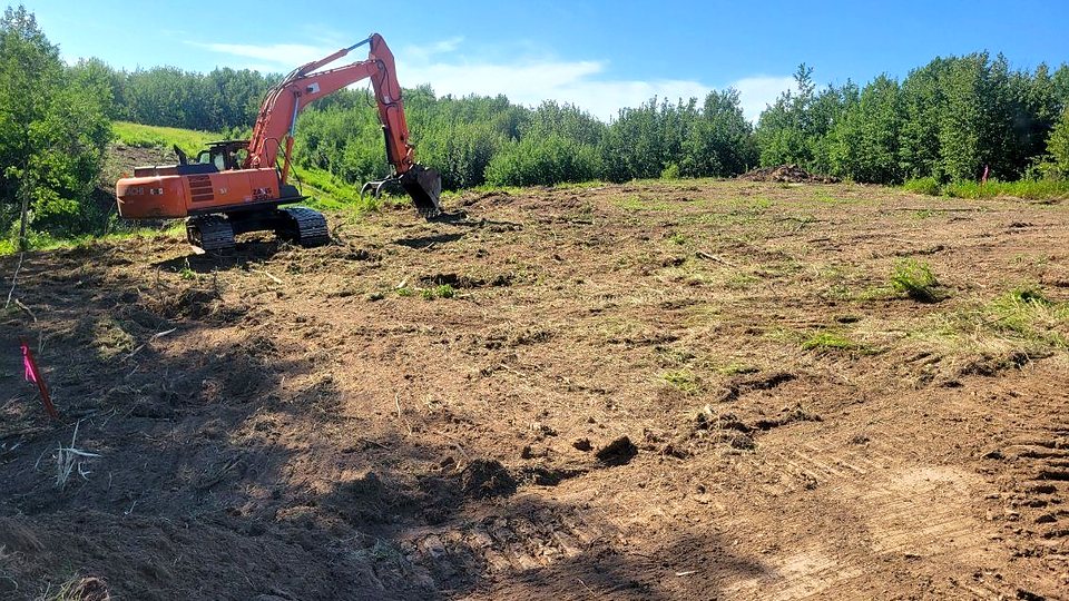 The group's Hitachi excavator working a cleared slope