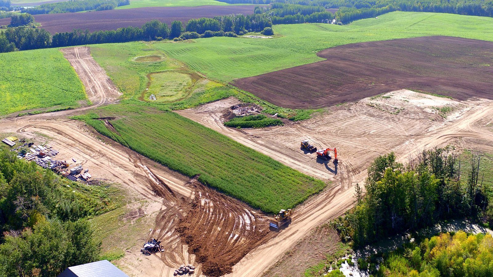Earthworks at the group's own Test Facility from the air: a dozer, an excavator and a loader sharing one site, its haul roads and its laydown yard